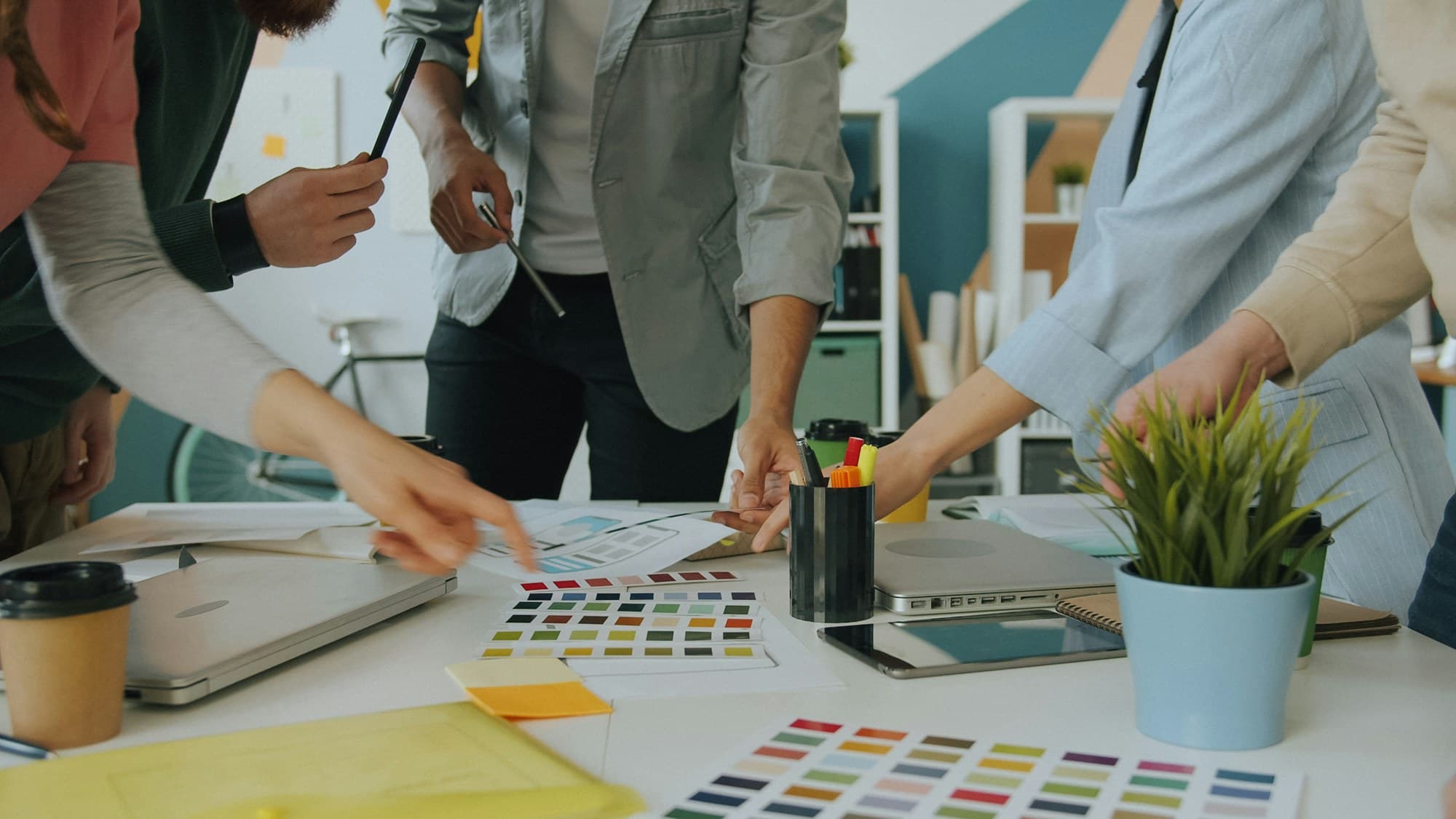 Designers choosing colours from palettes on a table