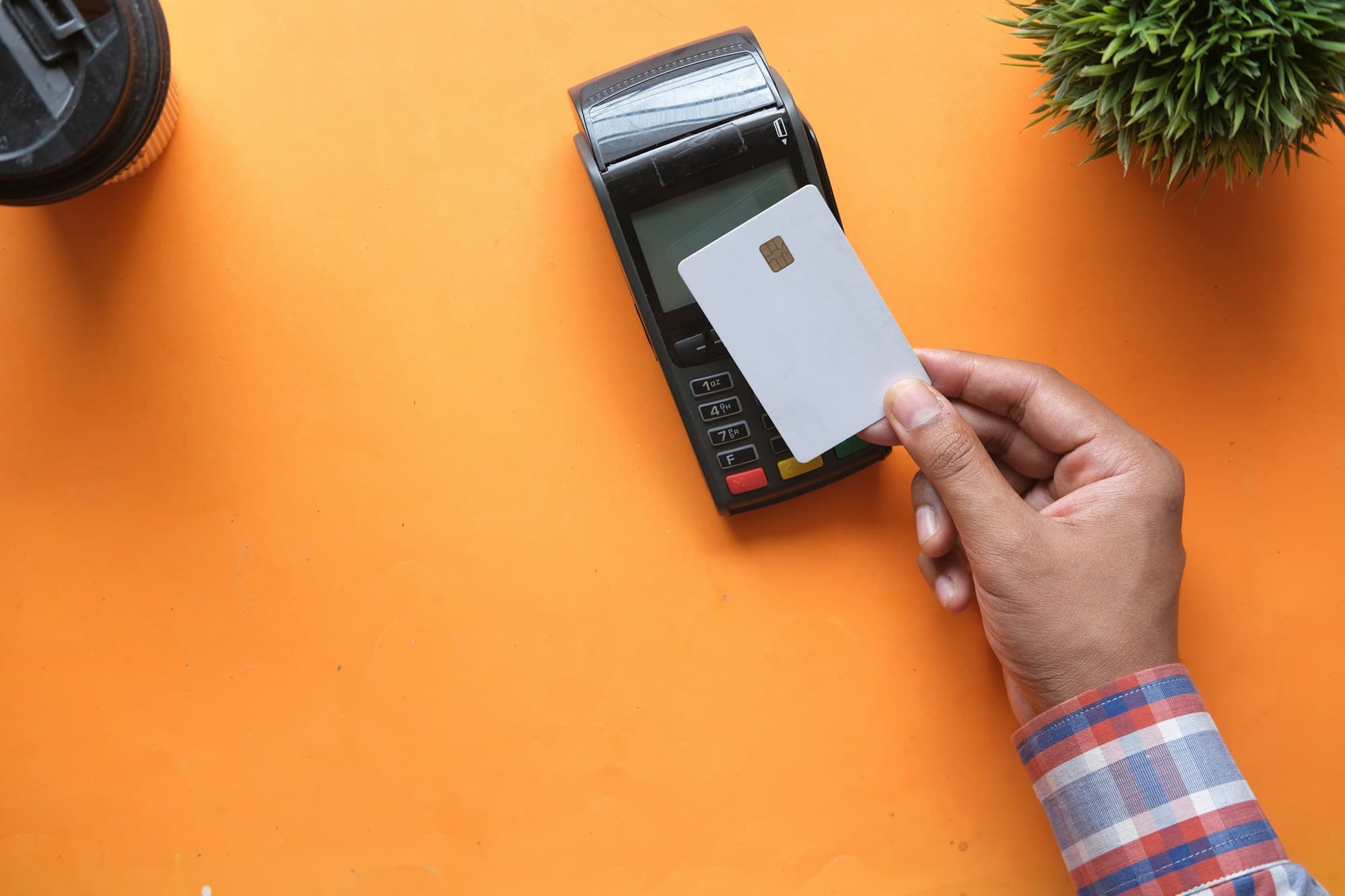 Card held near a payment terminal